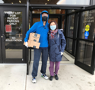 Pictured: Hui Zhang and her son Nelson Zhang on Mother's Day weekend dropping off their donation of 500 surgical masks and 100 N95 masks. 