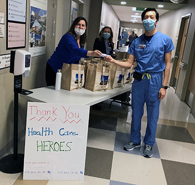 Pictured (L-R): Kim Goryeb, customer satisfaction manager for Morristown Medical Center, and Filipa Molina, patient experience assistant manager for Morristown Medical Center, distributing Perlier skincare donations to Morristown Medical Center team members. 