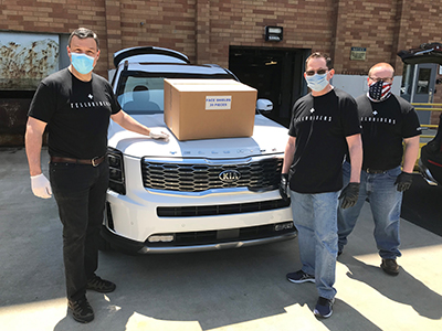 Members of the Kia Motors America, Inc. eastern region team delivering 24 boxes of face shields for frontline workers. 